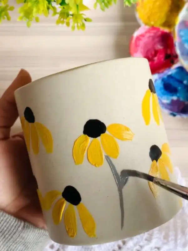 Drooping Black Eyed Susans on Speckled Clay