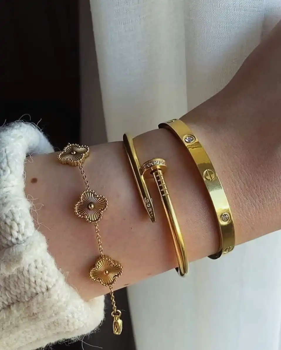 Three Piece Gold Stack Under a Knit Sleeve