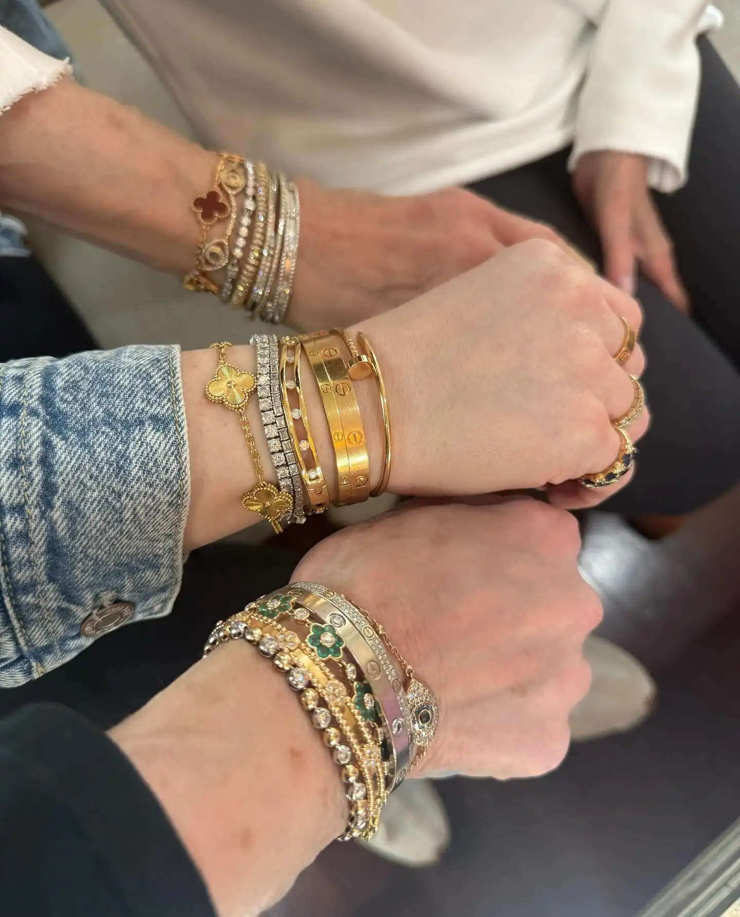 Full Gold Bangle Stack Over a Denim Sleeve