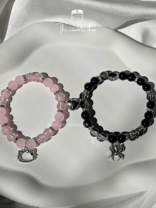 Black Bead Bracelet With a Spider Charm and Heart Halves
