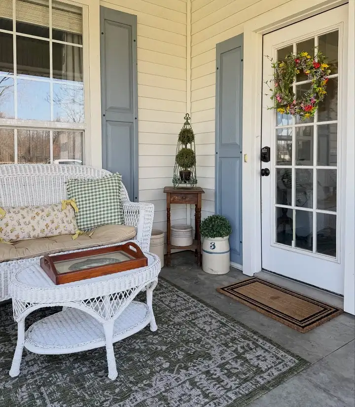 16 Minimalist Front Porch Ideas That Look Expensive on a Budget 7 Thrifted Crocks and a Vintage Side Table in One Corner