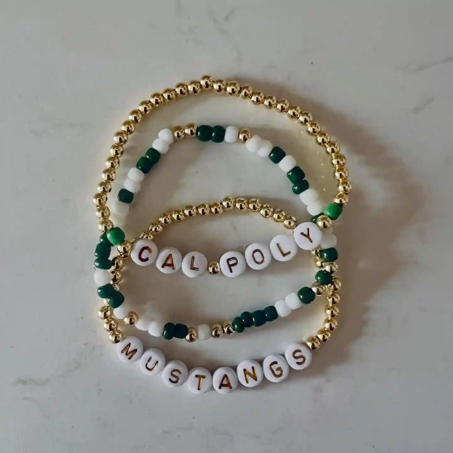 15 Back to School Bracelet Ideas to Trade 16 14. School Name Sets That Pair Plain Gold Rows With a Spelled Out Mascot
