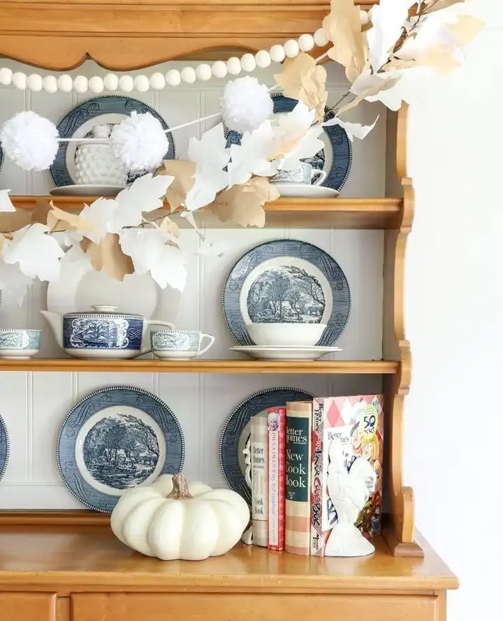 Paper Leaf Garland and Yarn Pompoms on a China Hutch