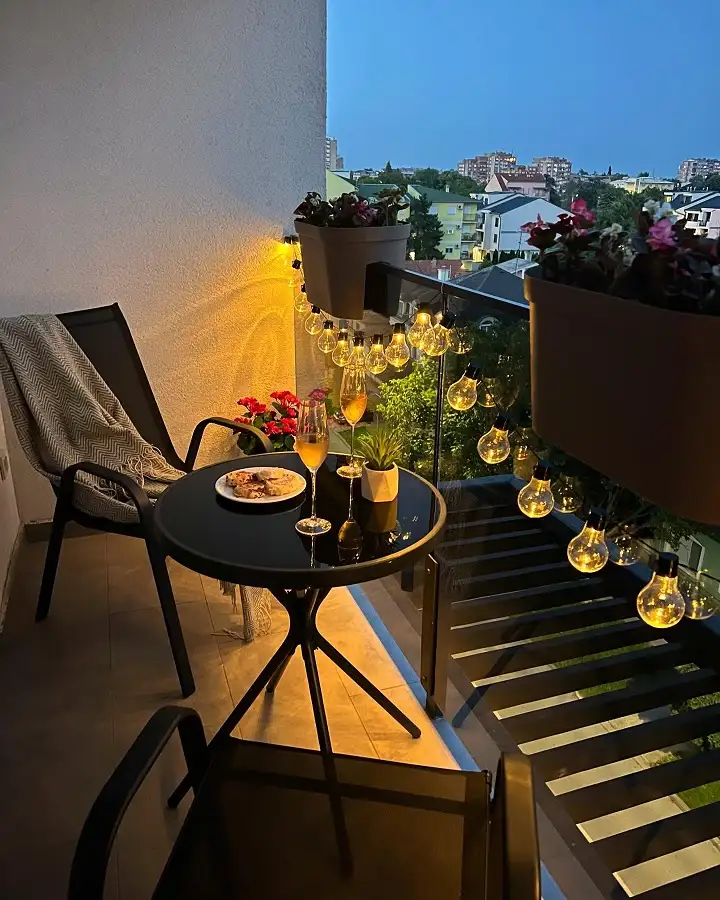 15 Summer Small Balcony Entertaining Ideas 12 10. Hang String Lights Directly From Your Planters