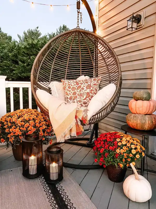 Cozy Fall Balcony Decor: 14 Ideas for Small Spaces 9 7. Stack Three Pumpkins on a Side Table for Instant Height